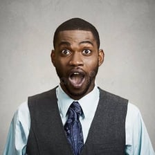 A person reacting skeptically to surprising information.