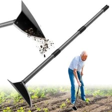 Garden hoe digging a hole in a cultivated plot