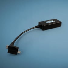 A small electronic dongle adapter with connector plugs