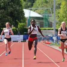 Runners sprinting down a track.