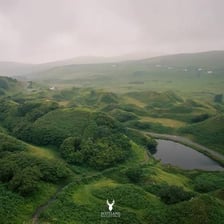 A narrow, secluded valley surrounded by green hills