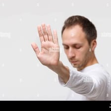 A person turning away from an object they do not want.