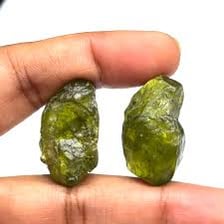 Green peridot crystals and a cut peridot gem.