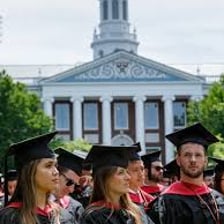 Students receiving graduate business degrees at a commencement ceremony