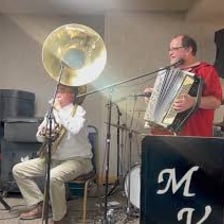 A musician playing a tuba in a polka band
