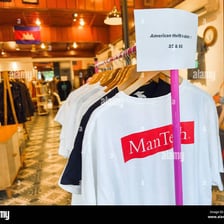 A rack of destination-themed souvenir T-shirts
