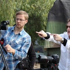 A film director giving instructions to actors during a scene