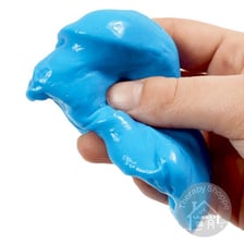 A glossy gooey lump of slime on a surface.