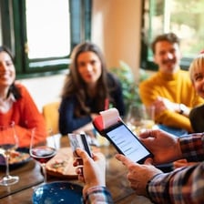A diner paying a restaurant check for a group