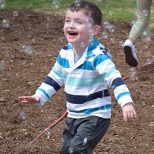 A young child playing outdoors.