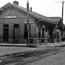 A railroad train stopped at a station platform.