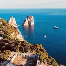 The rocky coastline and Faraglioni sea stacks of Capri, Italy