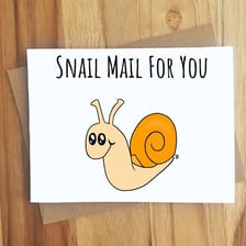 A snail beside a handwritten letter and envelope