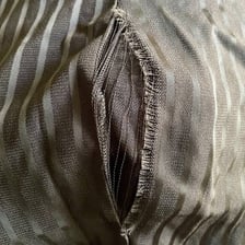 A close-up view of a tear in fabric.