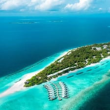A small island surrounded by blue water