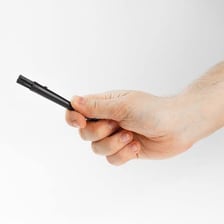 A person holding an object while gesturing that it should be kept