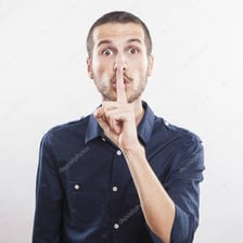 A person quietly signaling for someone’s attention