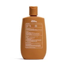 A bottle of tanning oil displaying an SPF rating