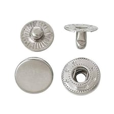 A metal snap fastener attached to a garment