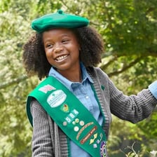 A Girl Scout wearing the organization’s uniform.