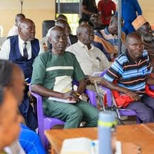 An older community leader addressing a group.
