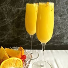 Several brunch mimosas made with sparkling wine and orange juice.