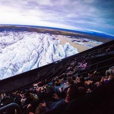 A large IMAX screen inside a museum theater