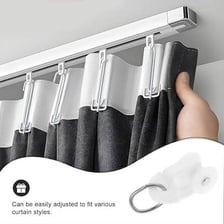 An I-shaped curtain rail with hooks supporting a curtain