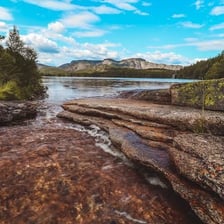 Water wearing away a rocky riverbank.