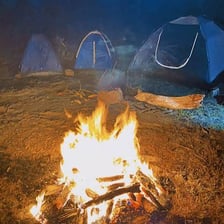 A campfire burning at a campsite