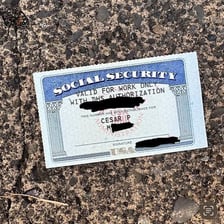 A Social Security card with its identifying number obscured.