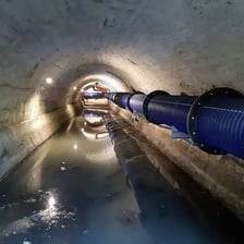 An underground sewer tunnel carrying wastewater.