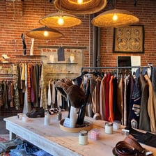 Racks of secondhand clothing in a thrift store.