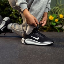 A person tying shoelaces again to make them secure.