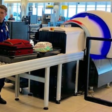 A TSA security checkpoint with luggage screening equipment.