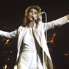 A pop singer performing before a concert audience