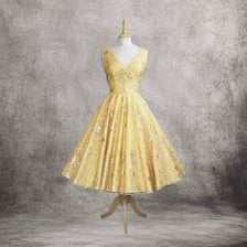 A vintage tea dress displayed as daytime party attire