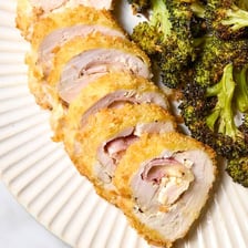 A sliced chicken cordon bleu showing its ham and cheese filling
