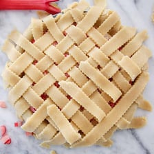 A fruit pie topped with a crisscross lattice pastry crust.