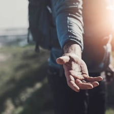 One person extending a helping hand to another.