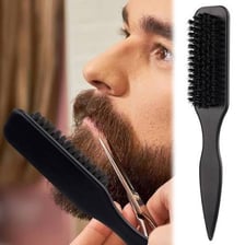 Stylist backcombing hair to add volume