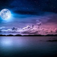 A full moon shining over a nighttime landscape