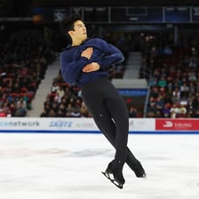 A figure skater performing a Lutz jump.