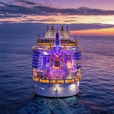 A large cruise ship traveling across the ocean