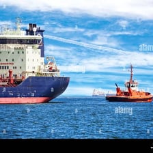 Tugboat towing another vessel on open water