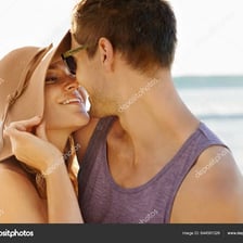 A couple sharing a brief kiss.