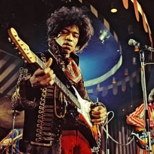 Jimi Hendrix performing on electric guitar.