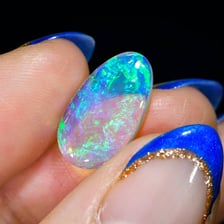 A polished opal showing iridescent flashes of color.
