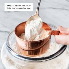 A measuring teaspoon being used with baking ingredients