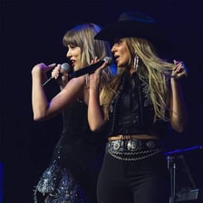 Two singers performing together in a musical duet.